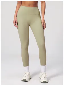 Close-up of high-waisted seamless yoga leggings in sage green with matte fabric detail