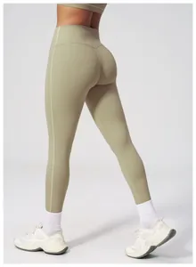Detail showing high waist seam and supportive sage green fabric on yoga leggings