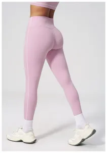 Detail of high-waist yoga leggings with white contrast stitching and matte texture