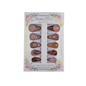 Brown almond press-on nails with zebra stripes, 3D floral carving and golden accents