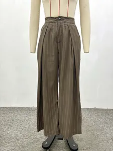 Detail of high waist brown striped wide leg trousers with button and pleat details