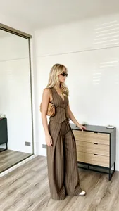 Close-up of brown pinstripe sleeveless vest and high-waisted wide-leg trousers set