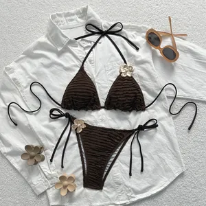 Brown ruched two-piece bikini featuring gold flower ornaments and pearl details