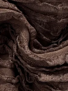 Close-up of textured ribbed fabric on a brown bikini set with metallic finish
