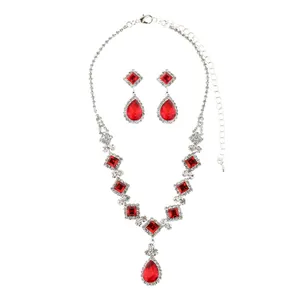 Elegant silver necklace and earrings set with red rubies and white crystals for brides