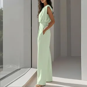 Side view of elegant mint green sleeveless jumpsuit with wide leg and cinched waist design