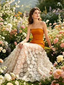 Elegant strapless dress with orange bodice and white floral polka dot tulle skirt
