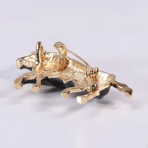 Close-up of the golden alloy pin back buckle on the ox-shaped animal brooch