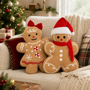 Close-up of gingerbread man and woman plush pillows with festive Christmas details