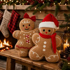 Plush gingerbread man dolls with Christmas scarves on a cozy wooden stool