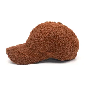 Close-up of deep brown teddy fleece baseball cap showing detailed fuzzy plush texture