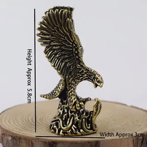 Detail showing the 5.8cm height of this eagle statue with polished brass finish