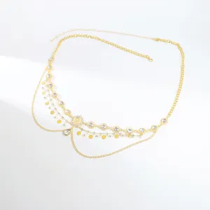 Detailed close-up of multi-layer gold body chain with rhinestones and lobster clasp