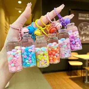 Close-up of 6 colorful drifting bottle keychains with glowing beads and snow sequins