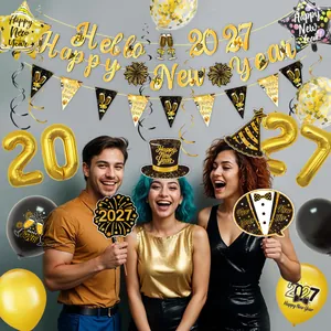 Detail of 2027 Happy New Year black and gold party decoration kit with balloons and photo props