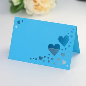 Macro view of laser-cut heart pattern on a sky blue stand-up wedding place card