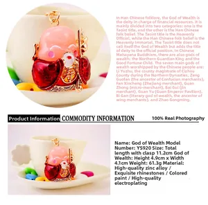 Detail of God of Wealth keychain with sparkling rhinestones and pink gold enamel