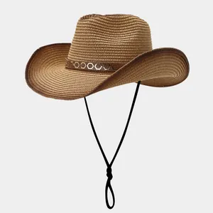 Détail d'un chapeau de paille tressé avec rivets dorés et cordon de menton noir