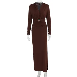 Detail of dark brown slim-fit dress with V-neck, waist buckle and side slit
