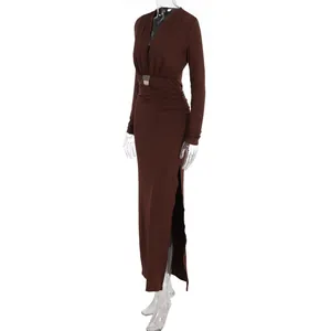 Detail view of the deep V-neck and metallic belt on this brown long sleeve dress