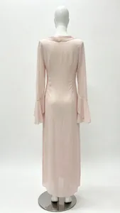 Macro view of long-sleeved pink dress featuring elegant layered ruffles on the cuffs