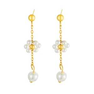 Detail of gold floral pearl drop earrings with long metal chain and elegant design
