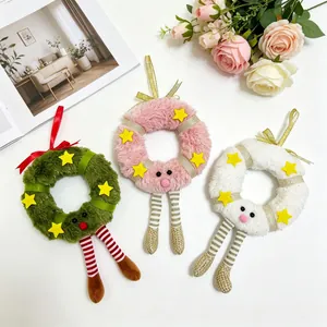 Three plush Christmas wreath ornaments in green, pink, and white with cute star accents
