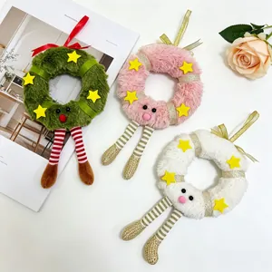 Detailed view of plush Christmas wreath ornaments with stars and striped legs on magazine