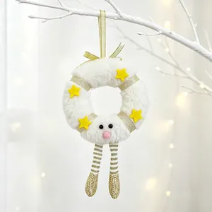 Close-up of white plush Christmas wreath ornament with gold stars and sequin legs
