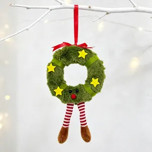 Close-up of reindeer plush wreath pendant hanging on a branch for Christmas decor