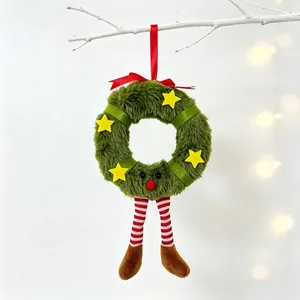 Detail view of plush Christmas wreath ornament with festive striped legs and red ribbon