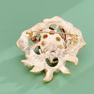 Retro crystal rose flower brooch in gold plated metal with secure pin closure