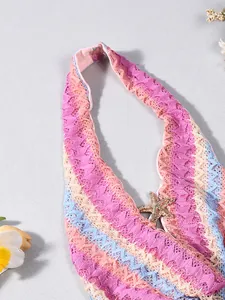 Detail of crochet halter top with colorful wavy patterns and golden starfish charm