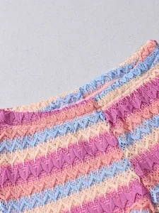 Macro shot of colorful wave crochet knit fabric with pink and blue chevron patterns