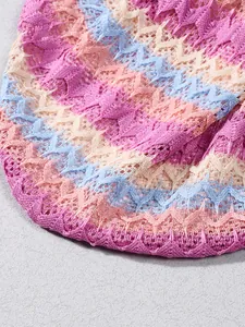 Close-up of knit fabric detail featuring colorful wavy zigzag patterns and soft texture