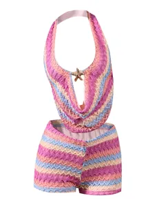 Close-up of crochet hollow knit fabric with colorful wave stripes and starfish detail