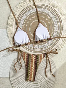 Close-up of bohemian crochet knit bikini set with zigzag stripe pattern on a woven mat