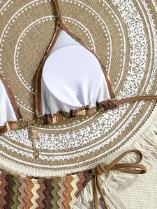 Detail of knit zigzag bikini set with metal coconut tree pendants on the top