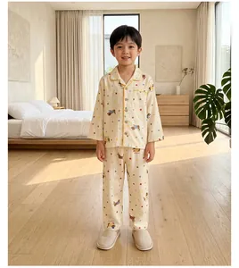 Detail of children's cotton pajamas featuring cartoon puppy patterns and yellow piping