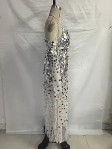 Detailed side view of silver sequins and white mesh fabric on a long evening gown