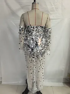 Detailed back view of white mesh evening gown with silver sequins and long sleeves