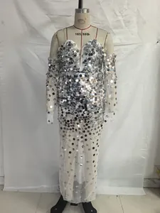 Detailed macro view of silver sequins and transparent mesh on elegant evening gown