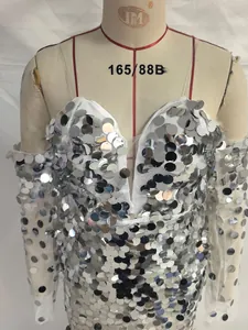Detail of silver sequins on white evening gown with mesh heart neckline and sleeves