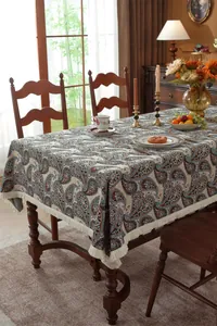 Close-up of vintage paisley jacquard tablecloth with elegant white fringe details