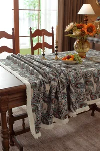 Close-up of vintage paisley floral table runner with elegant white fringe details