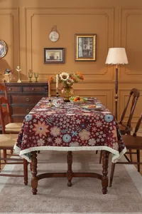 Close-up of vintage floral jacquard tablecloth with beige fringe tassels on edge