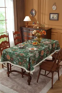 Close-up of vintage floral jacquard tablecloth with elegant white fringe details