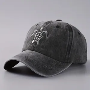 Unisex washed dark grey baseball cap featuring a detailed turtle embroidery pattern