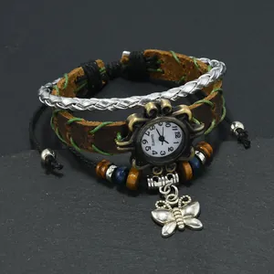 Detail of vintage woven leather watch with butterfly charm and bohemian beads