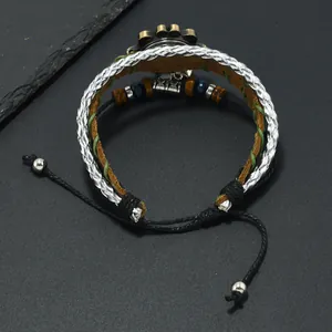 Detail of vintage bohemian multilayer leather bracelet with bronze gear and beads